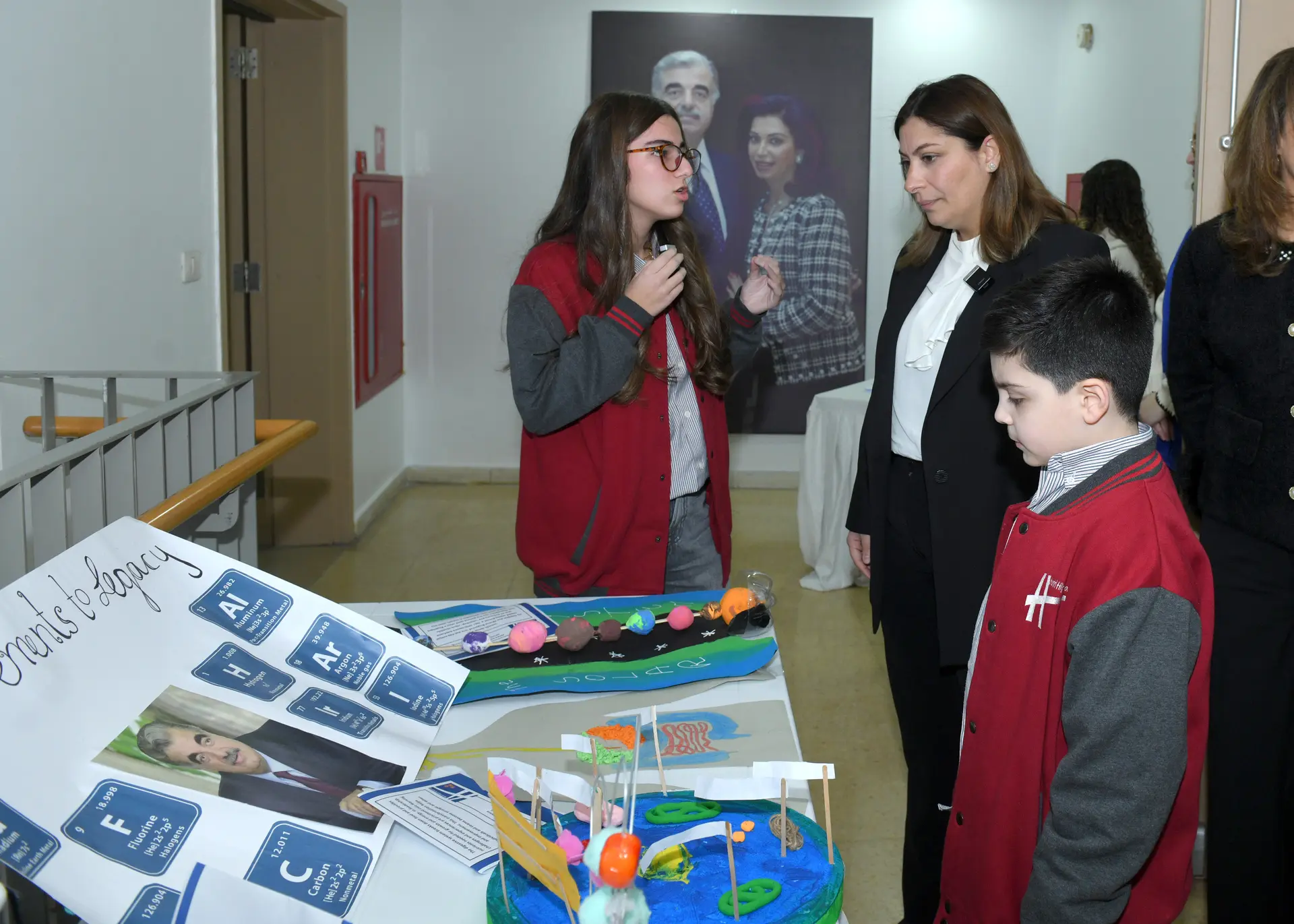 Students sharing projects at a school exhibition